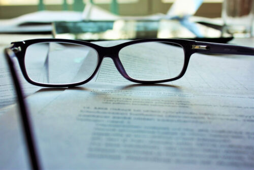 glasses with paperwork