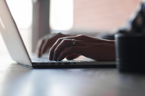 hands typing computer