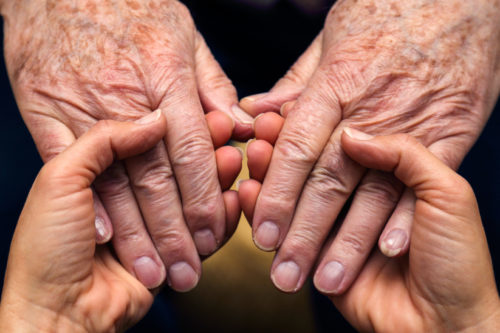 holding elder's hands