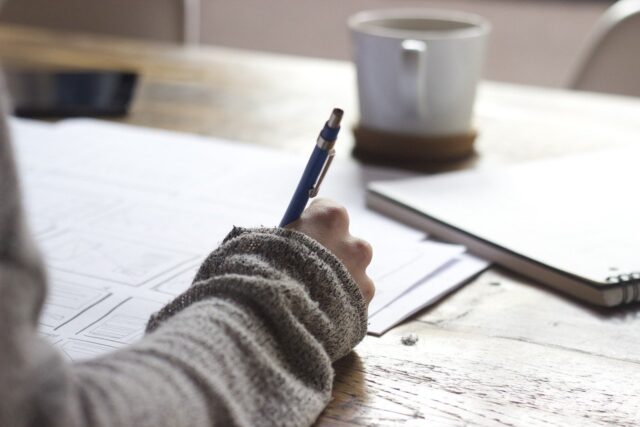 person writing notebook